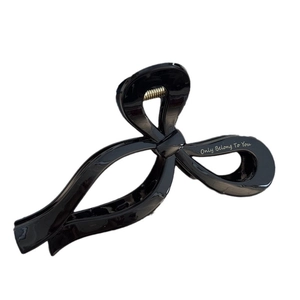 Minimalist black bow-shaped hair claw clip with white 'Only Belong To You' text