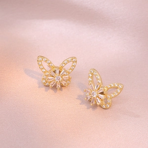 Exquisite 18K gold butterfly earrings with micro-pave cubic zirconia on pink silk fabric