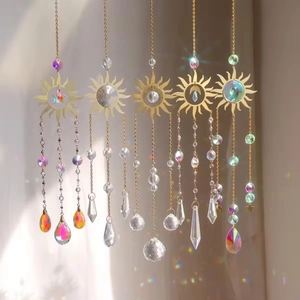 Set of 5 golden sun and moon crystal suncatchers with prisms hanging in natural light
