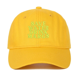Close-up of Save Water Drink Margs green embroidery on yellow cotton baseball cap