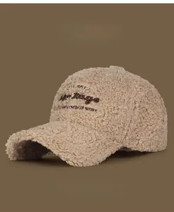 Detailed texture of beige lamb wool baseball cap with Vintage embroidery on brown background