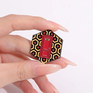 Gothic punk alloy enamel pin with The Shining Overlook Hotel carpet pattern and room 237 door