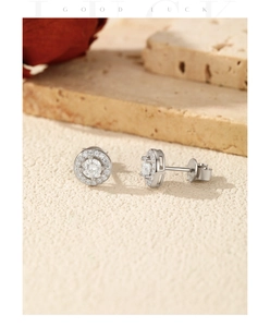 Macro detail of S925 sterling silver halo stud earrings with round moissanite stones