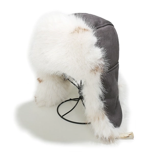 Detail of warm winter trapper hat with gray suede fabric and soft faux fox fur lining