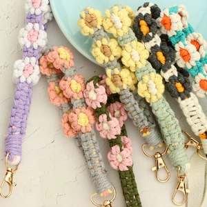 Handmade woven daisy flower wrist straps with colorful cotton yarn and gold lobster clasps
