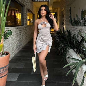 Détail de la robe licou beige clair avec fleurs 3D et fente latérale froncée