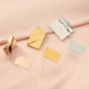 Detailed view of DIY envelope locket pendants in gold, rose gold and silver on silk