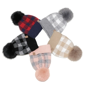 Winter beanie set with classic plaid patterns and fluffy faux fur pom poms for warmth