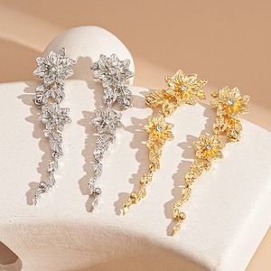 Elegant floral drop earrings with rhinestones in gold and silver metallic finish