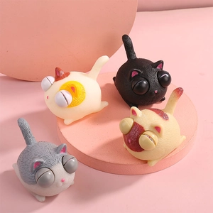 Set of 4 squeeze cat stress relief toys with popping eyes on pink display stands