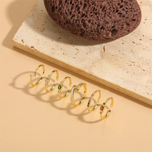 Set of six adjustable gold-plated rings with colorful zircon stones on stone base