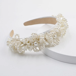 Detailed view of the wide baroque headband with white pearls and floral crystal accents