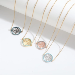 Detail of four Wishing Tree necklaces in black gold rose gold and silver finish