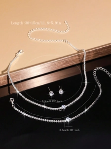Detailed view of silver necklace, bracelet and earrings set with clear zircon stones