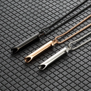 Mindful breathing necklaces in black, rose gold, and silver on a textured surface