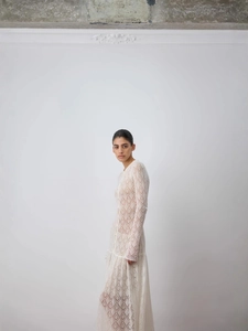 Robe longue élégante en dentelle blanche à manches longues avec texture ajourée