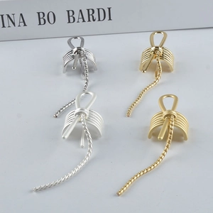 Minimalist metallic bow hair clip with elegant tassel in gold and silver finish