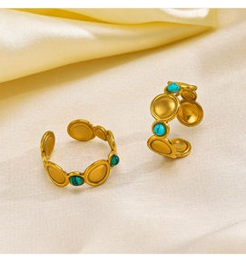 Detailed view of gold plated stainless steel rings with malachite and turquoise inlays