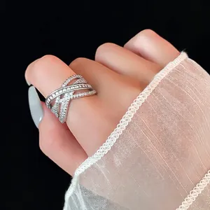 Luxurious multi-layer silver criss-cross ring with sparkling cubic zirconia on model hand