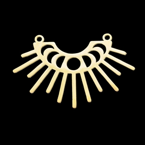 Detailed view of a gold crescent moon and sunburst cutout charm for jewelry making