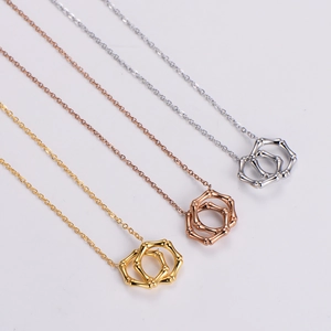 Bamboo style interlocking double ring necklace set in gold, rose gold, and silver finishes