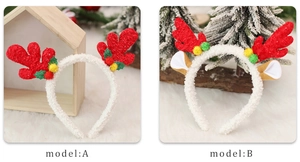 Detail view of red reindeer antler headbands with plush fur and festive leaf decorations