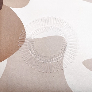 Macro detail of clear flexible circular hair comb showing dense teeth and elastic structure