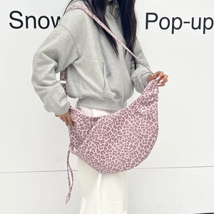 Pink leopard print hobo bag with adjustable wide shoulder strap and crescent shape