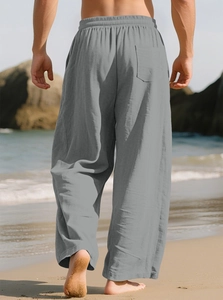 Men's casual grey linen trousers with elastic waist and back pocket on beach background