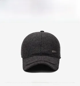 Detail view of thickened dark grey wool fabric and silver metal buckle on winter hat