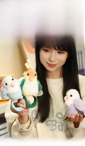 Close-up of soft plush bird slap bracelets in pastel blue, yellow, and purple colors