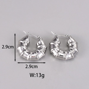 Detailed view of silver hoop earrings showing 2.9cm size and textured ribbed design