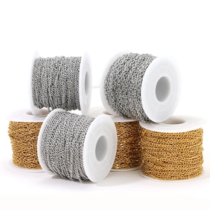 Gold and silver stainless steel cable chains on white spools for jewelry making