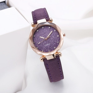 Macro shot of starry purple dial with quartz movement and faceted crystal watch bezel