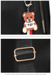Close-up of black nylon backpack details featuring teddy bear charm and golden hardware