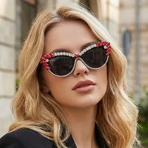 Chic cat eye sunglasses with red and white rhinestones on black frame with dark lenses