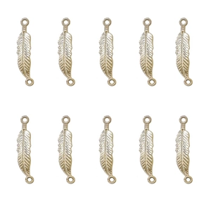 Detailed macro view of ten gold-colored vintage feather charms for jewelry making