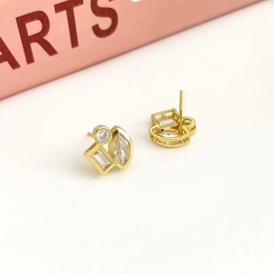 Macro shot of 18K gold-plated geometric earrings with clear round and square zircons