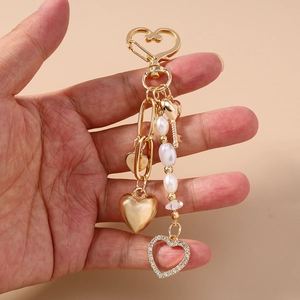 Starfish and pearl beaded heart keychain in gold finish with sparkling rhinestones