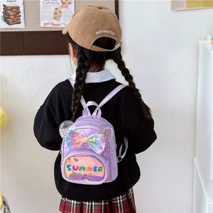Cute purple sequin princess backpack with bow design for kindergarten girls on a model