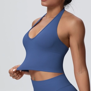 Close-up showing the high elasticity and ribbed hem of the dark blue yoga sports bra