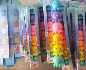 Stacked packs of colorful octopus building block toys in transparent window display boxes