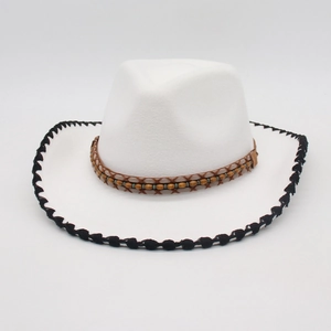 Detail of white cowboy hat featuring ethnic beaded band and black braided edge trim