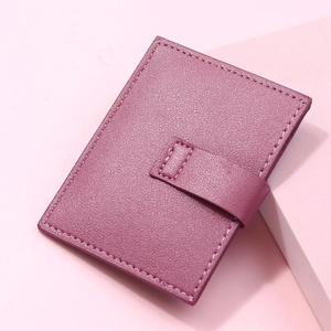 Detailed view of purple lychee pattern leather card holder with secure snap button closure