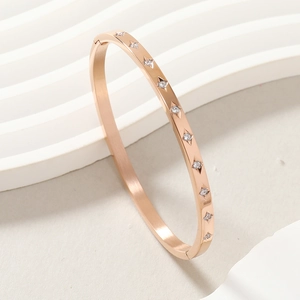 Rose gold stainless steel bangle with ten star-set white zircons for women