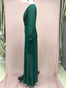 Close-up of emerald green sequin long-sleeved dress with elegant waist design details