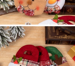 Close-up of Christmas felt gift bags featuring Santa, snowman and reindeer on wood