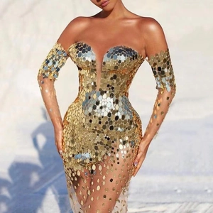 Elegant off-shoulder gold sequin evening gown with mesh sleeves on an outdoor background