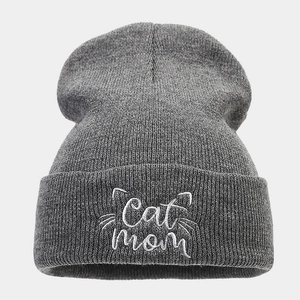 Detailed view of Cat Mom embroidery on a dark grey knitted beanie for women
