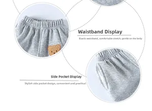 Detail view of grey kids joggers with elastic waistband and bear embroidery applique